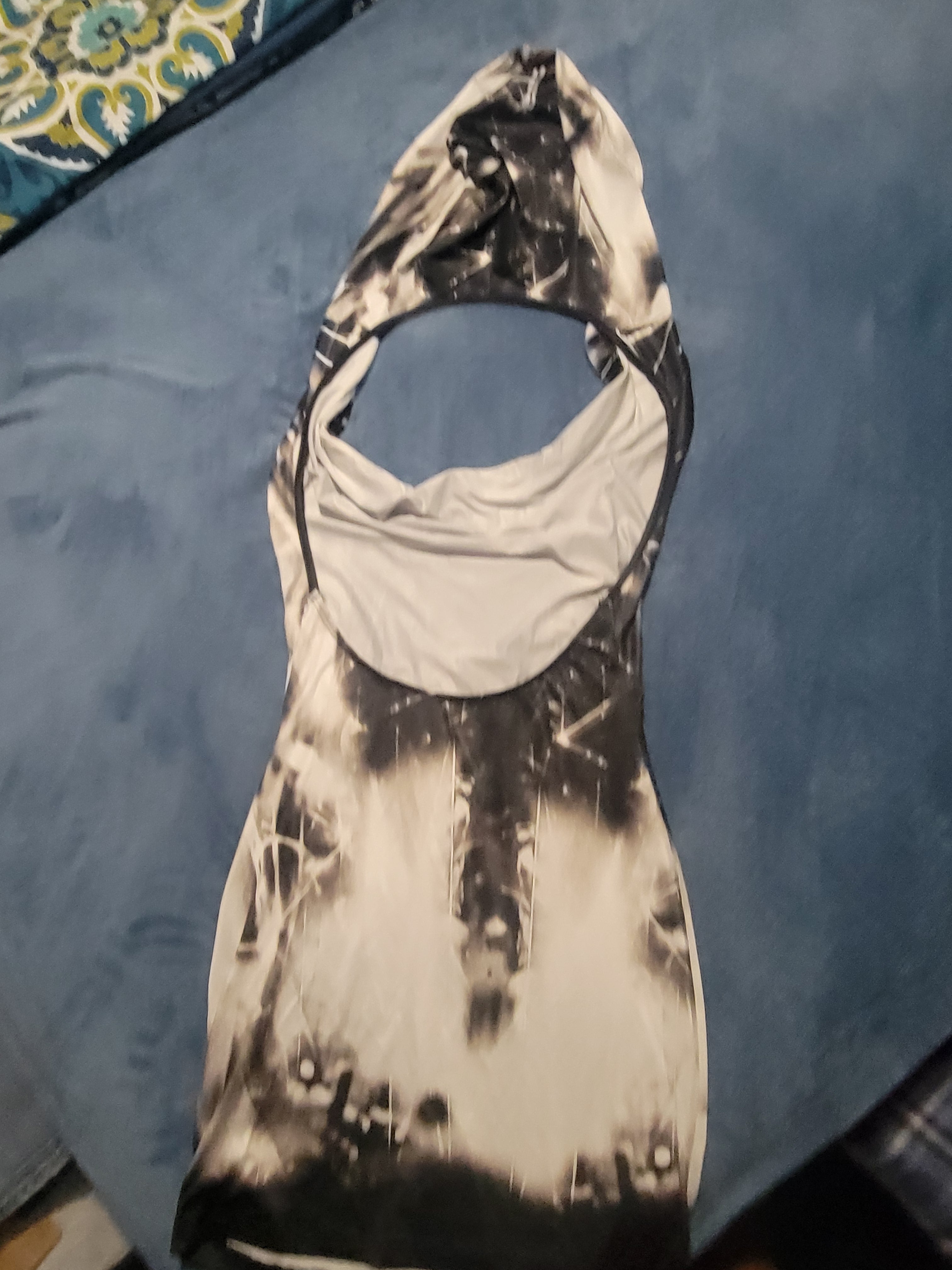 Black and white mini dress with hoodie styles throw over  deeb cleavage.